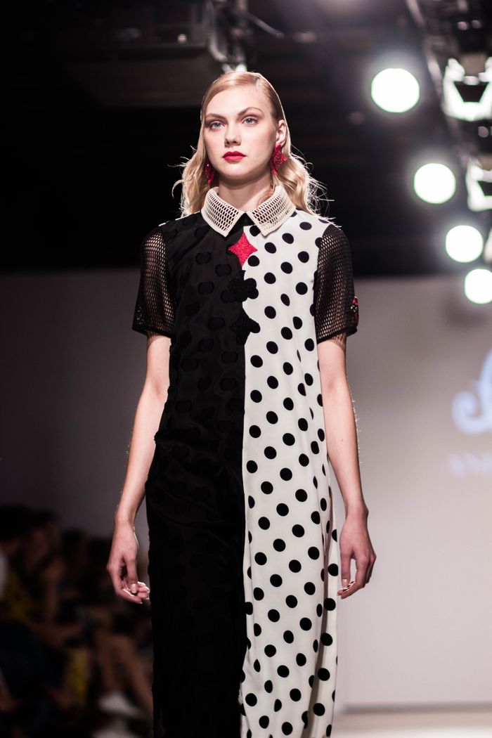 Crafting Captivating Headlines: Your awesome post title goes here Model walking the runway in a unique polka dot and solid color dress during a fashion show.
